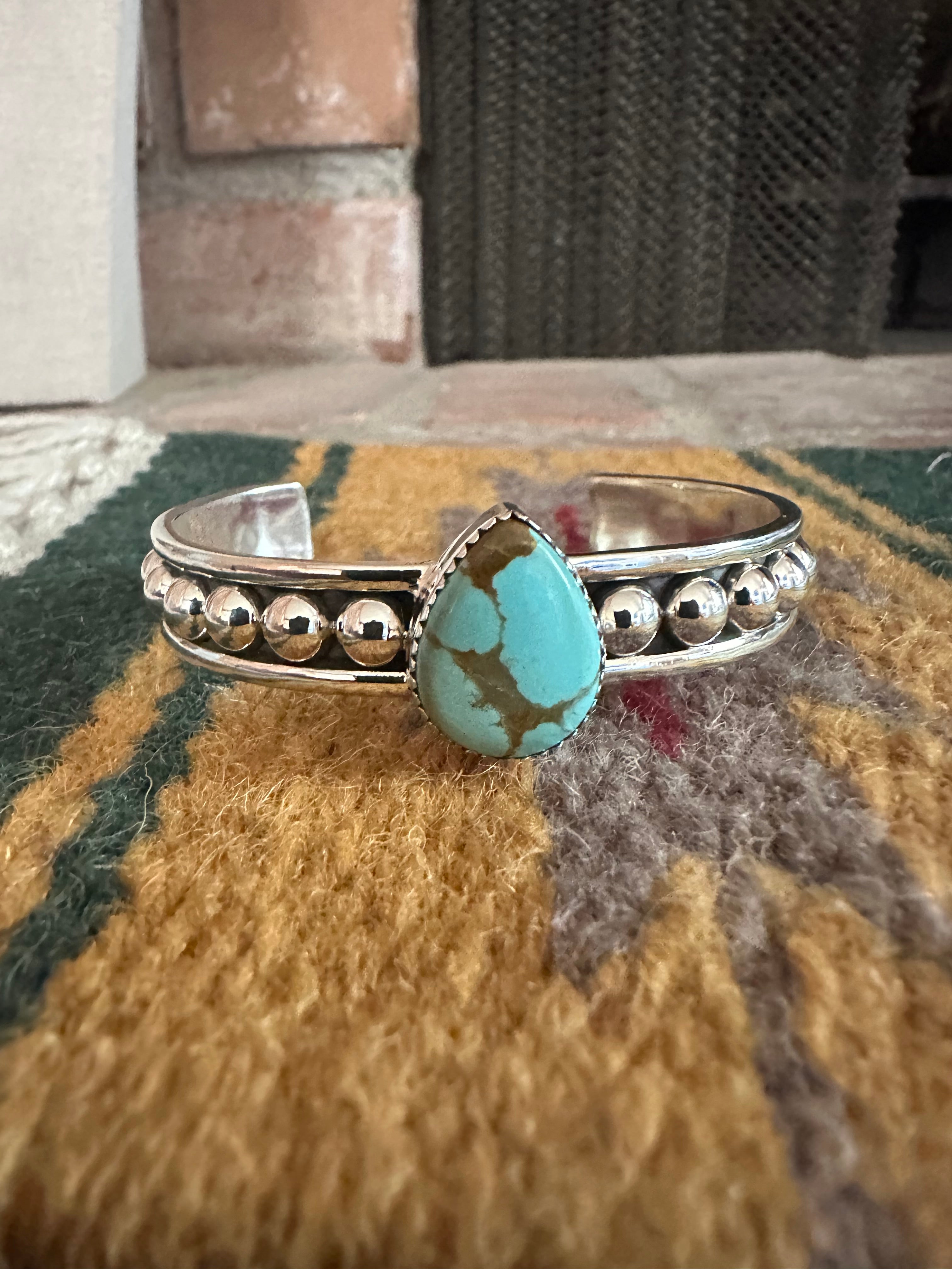 Handcrafted silver outlet and turquoise adjustable bracelet.